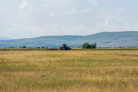 Tractor plowing fields. Stock Photos