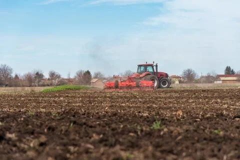 Tractor plowing fields. Stock Photos