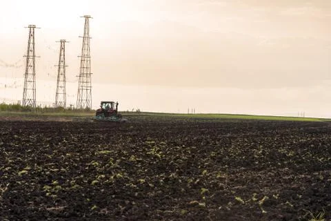 Tractor plowing fields. Stock Photos