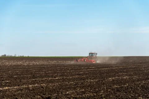 Tractor plowing fields. Stock Photos
