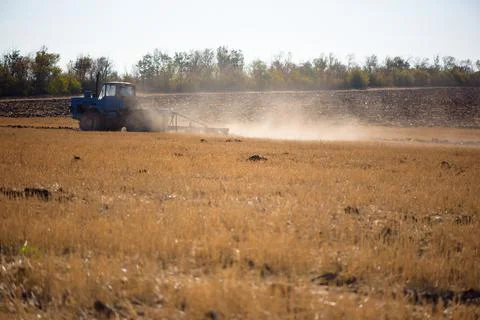 Tractor plowing fields -preparing land for sowing Stock Photos