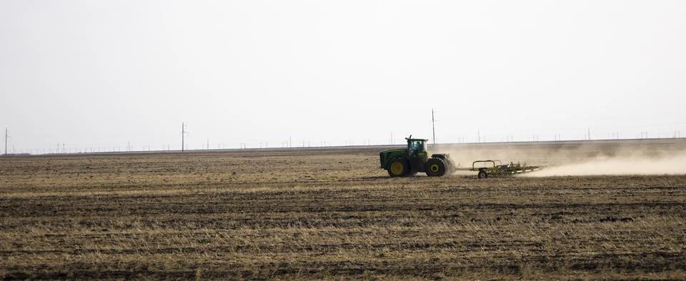 Tractor plowing fields -preparing land for sowing Stock Photos