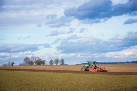 Tractor plowing ground in the spring Stock Photos