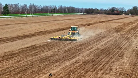 Tractor Plowing A Large Field, Preparing The Soil For Planting Crops. - aerial Stock Footage 308769235