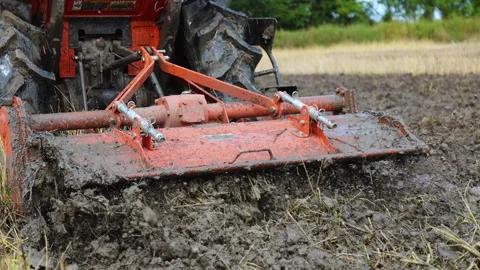 Tractor plowing muddy rice field, mud in the paddy, showing soil texture Stock Footage 328220726