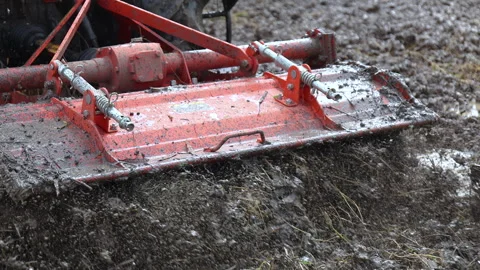 Tractor plowing muddy rice field, mud in the paddy, showing soil texture Stock Footage 328220815