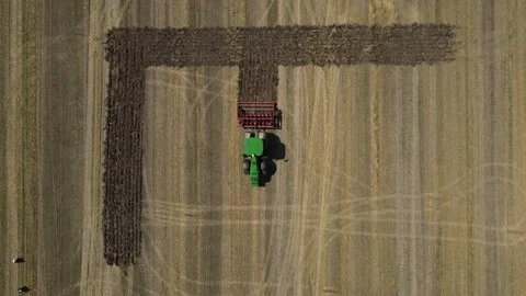 Tractor Plowing Patterns in Field. Aerial view of a tractor creating geometric Stock Footage 272267300