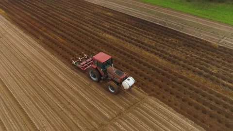 Tractor Plowing Rows in Potato Field Aerial Stock Footage 146859622