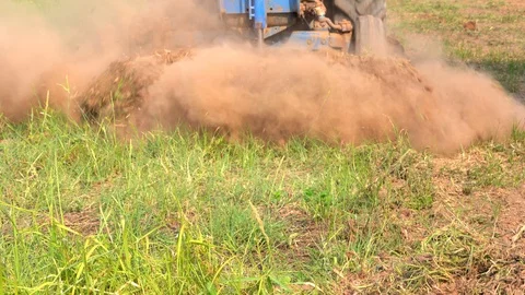 Tractor plowing soil grass filed in farm agriculture for planting tree Stock Footage 106583102