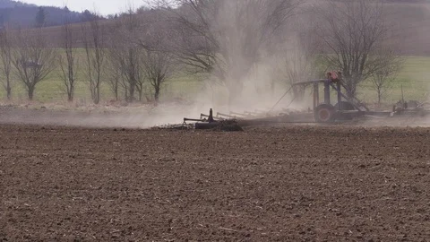 Tractor plowing soil to prepare field for seeding season Stock Footage 126816652