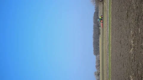 Tractor plowing the soil in spring closing the moisture, preparing the land for Stock Footage 172347706