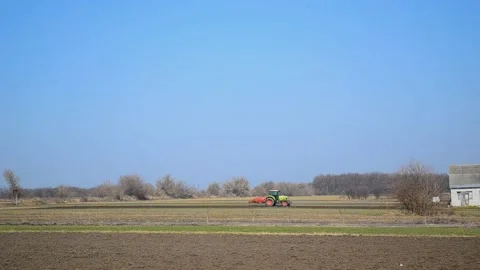 Tractor plowing the soil in spring closing the moisture, preparing the land for Stock Footage 172347734