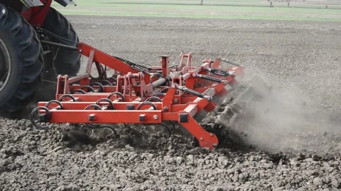Tractor plowing the soil in spring closing the moisture, preparing the land for Stock Footage 177556253