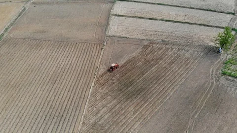 Tractor is plowing soil with video top view, Stock Footage 109213672