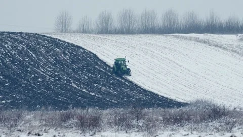 Tractor Plowing Up the Soil Winter Time Vidéo 146789737