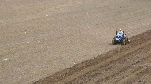 Tractor plowing the spring field (01) Stock Footage