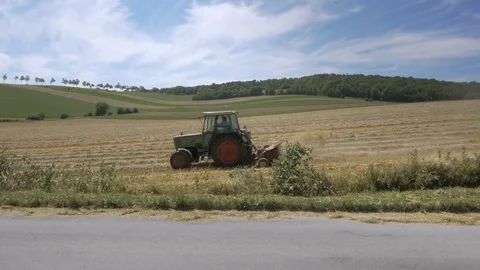 Tractor plowing wheat field in 60fps. Edit sequence. Video stock 80252870