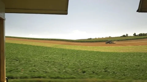 Tractor plowing wheat field. View from the moving train. Video stock 81481550