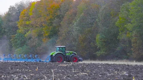 Tractor plows agricultural field. Processing the field with a tractor. The Video stock 143022956
