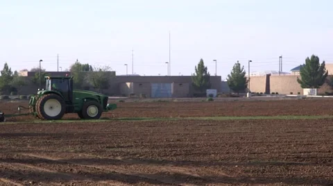 Tractor plows dirt field Stock Footage 47682642