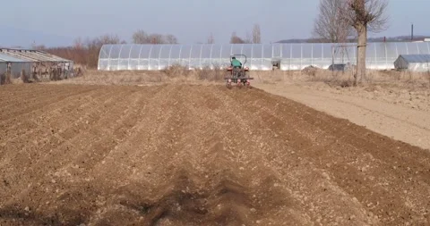 Tractor plows the field aerial. Stockbeeldmateriaal 187619415
