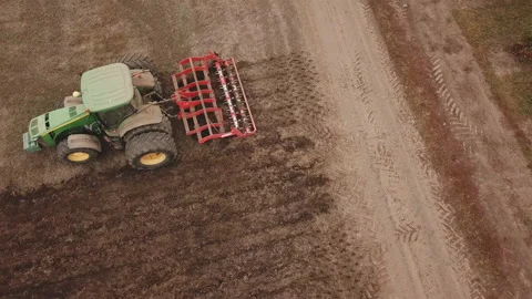 Tractor plows a field, aerial view Stock Footage 130076524