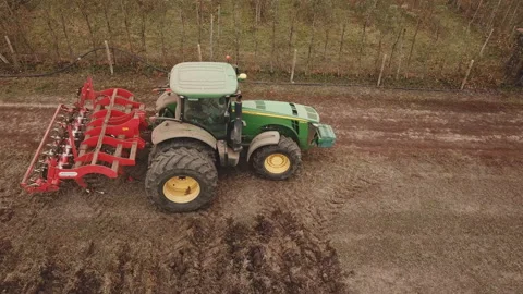 Tractor plows a field, aerial view Video stock 130354092
