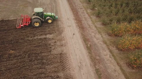 Tractor plows a field, aerial view Stock Footage 130493161