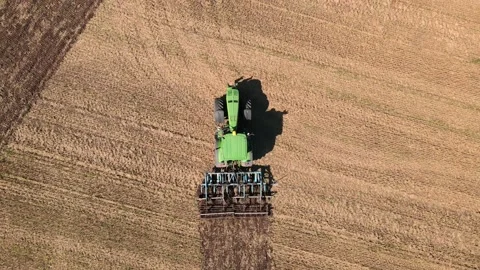 A tractor plows the field after harvesting the crop Stock Footage 210880652