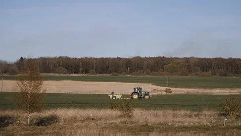 A tractor plows the field and sows simply harvest Stock Footage 129894226