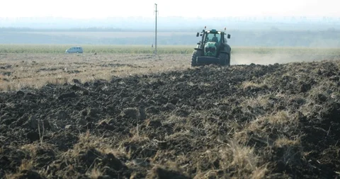 Tractor plows in the field Stock Footage 118712237