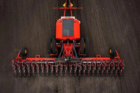 Tractor plows the field. Stock Photos