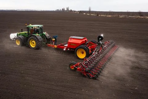 Tractor plows the field. Stock Photos