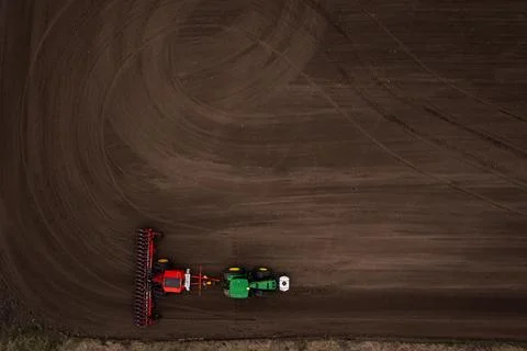 Tractor plows the field. Stock Photos