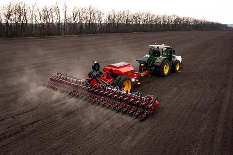 Tractor plows the field. Stock Photos