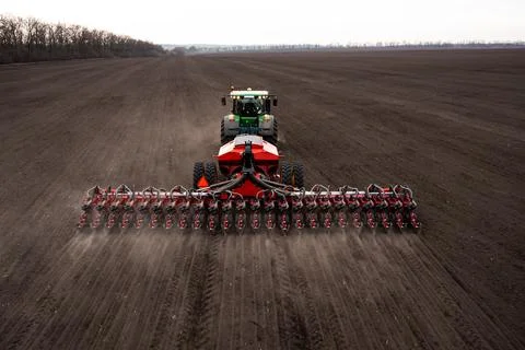 Tractor plows the field. Stock Photos