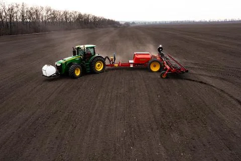 Tractor plows the field. Stock Photos