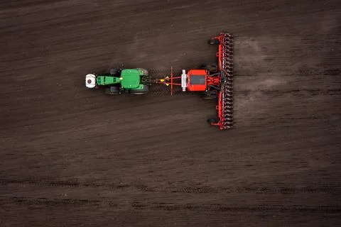 Tractor plows the field. Stock Photos