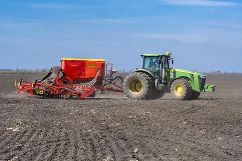 Tractor plows the field. Stock Photos