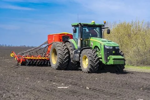 Tractor plows the field. Stock Photos