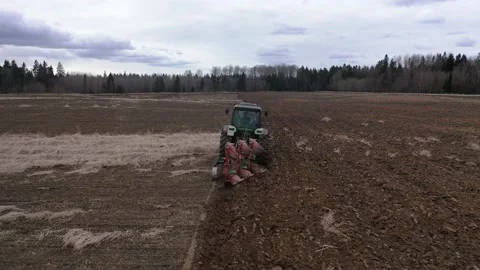 Tractor plows the field with a plow Stock Footage 147584803