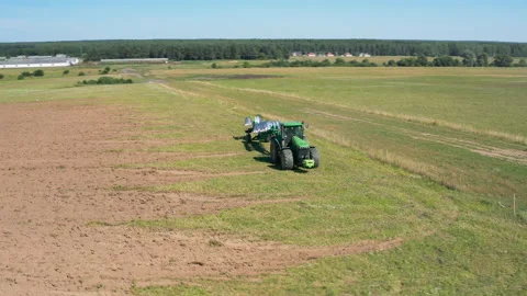 Tractor plows the field by plow, plowing fields. Farmer preparing the soil for Video stock 144096631