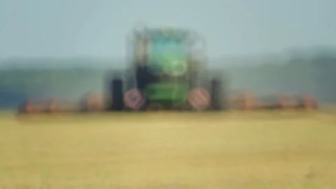 The tractor plows the field with plows before sowing. Stock Footage 93697408