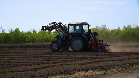 Tractor plows a field for seedlings Видео 123045682