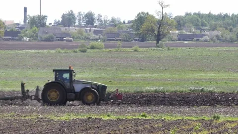Tractor plows the field. side view of a large tractor at work Stock Footage 201887998