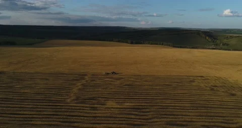 The tractor plows the field for sowing wheat. A beautiful new tractor. Stock Footage 139622658