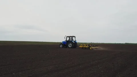A tractor plows a field in the spring. Stock Footage 274163212