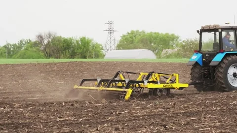 A tractor plows a field in the spring. Stock Footage 274164183