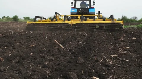 A tractor plows a field in the spring. Stock Footage 274164357