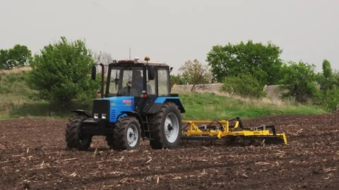 A tractor plows a field in the spring. Stock Footage 274164399